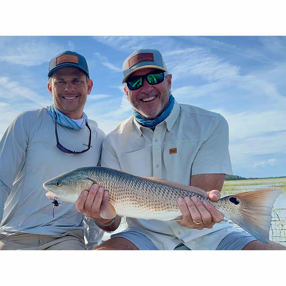 Captain Tuck Scott and a pleased client