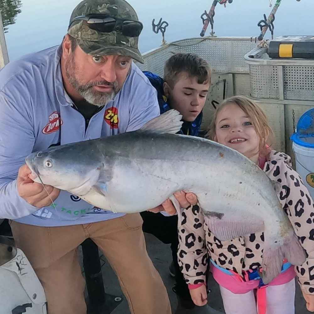 Captain Chris Simpson and family with a winter blue caught this weekend