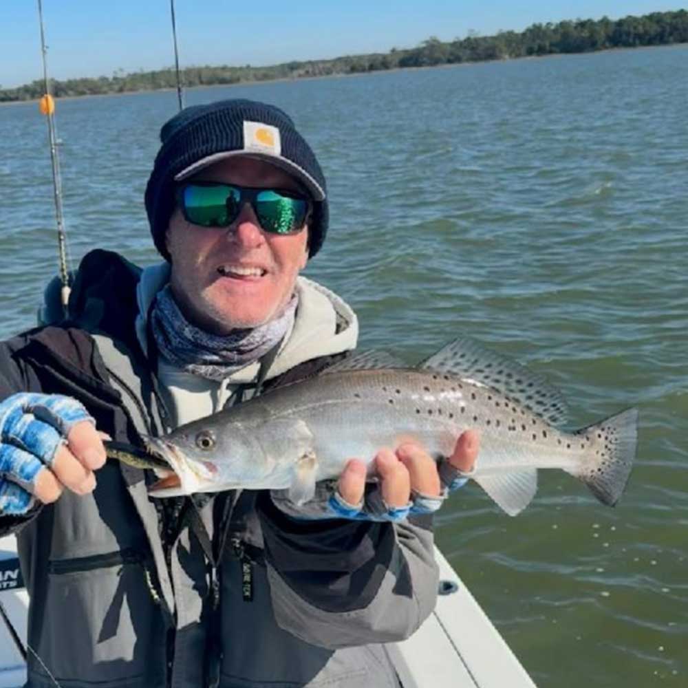 Captain Greg Holmes with a nice trout this week