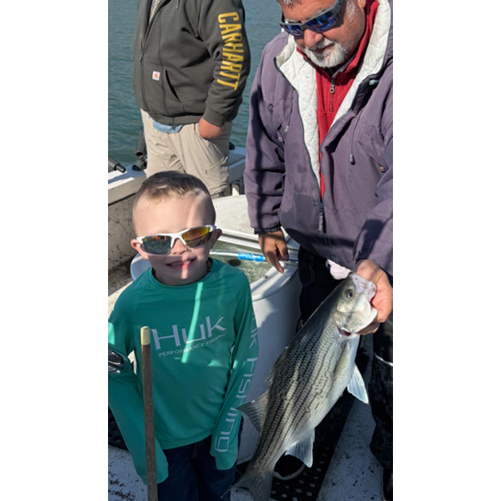 A happy young angler with Captain Chip Hamilton