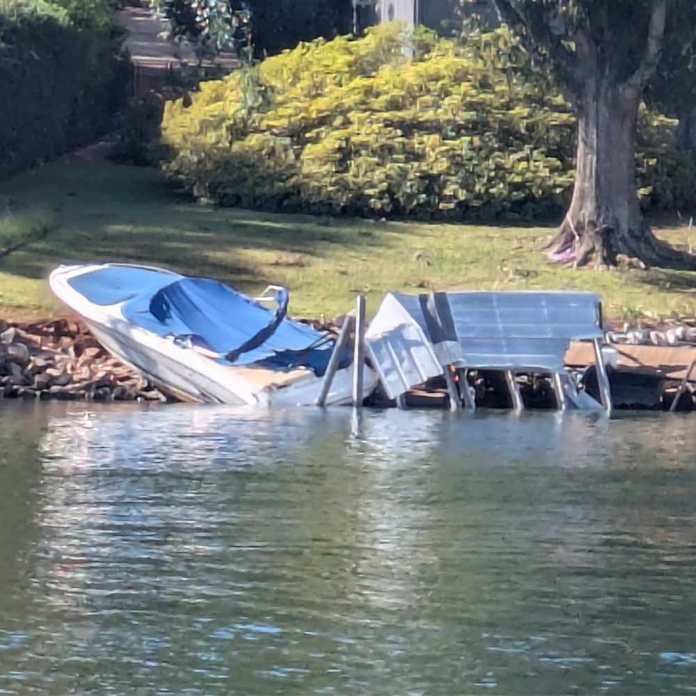 A boat and dock on Keowee washed ashore by the storm