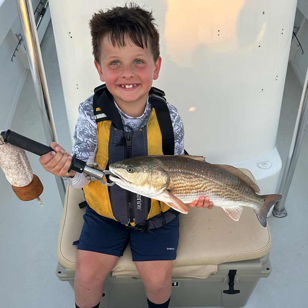 A happy young angler with Captain Smiley Fishing Charters