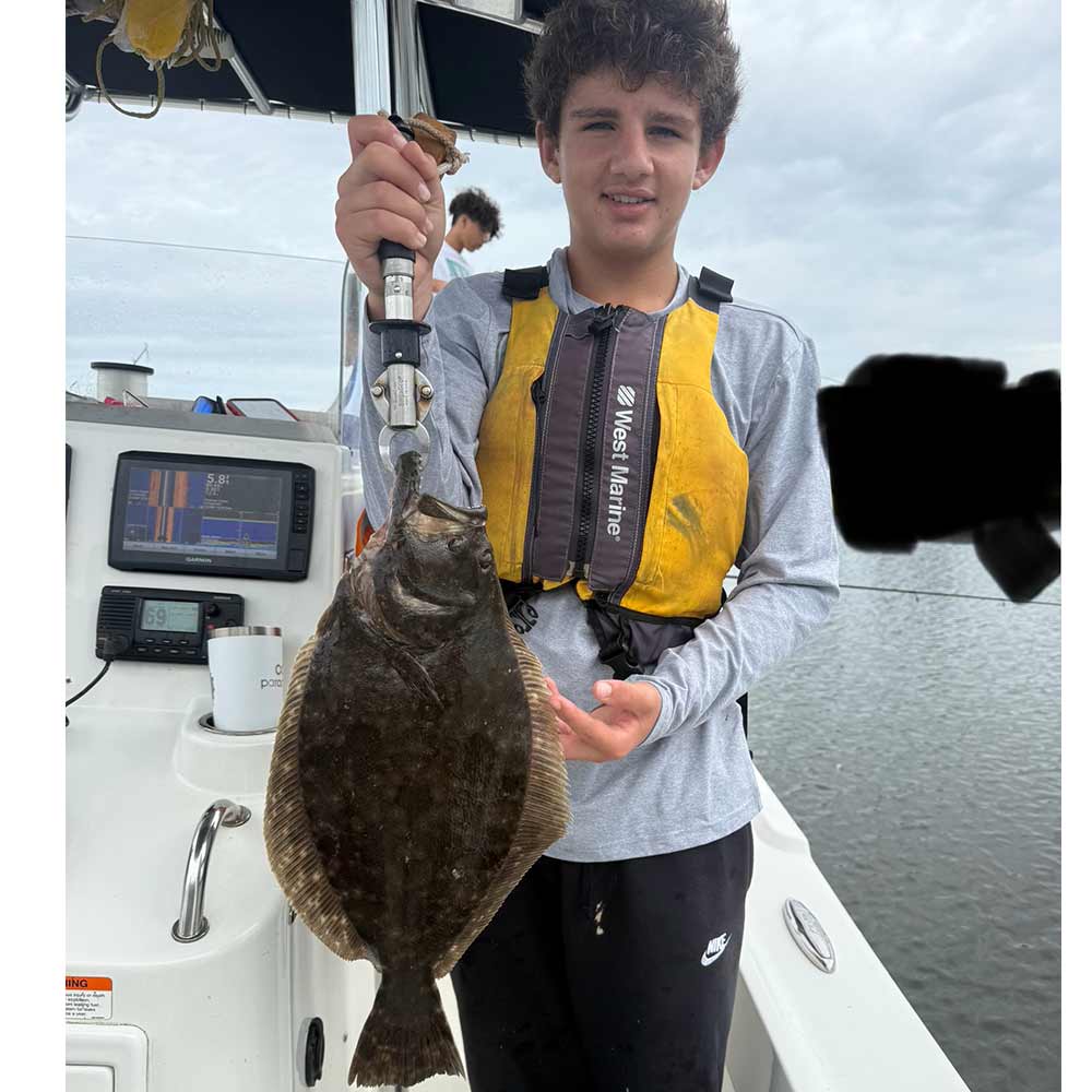 A good flounder caught with Captain Smiley Fishing Charters 
