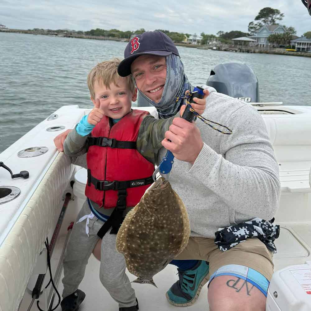 A happy young angler with Fish Finder Fishing Charters