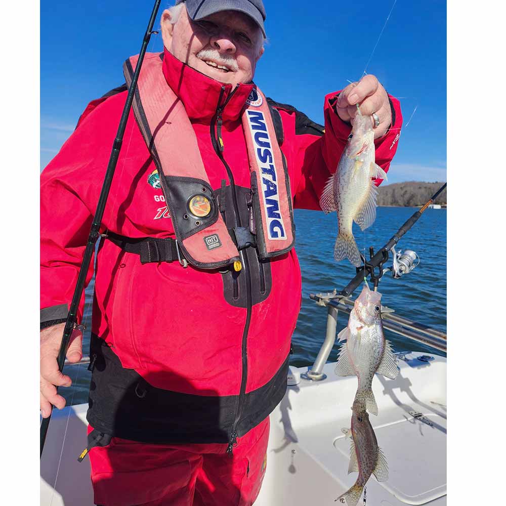 Local legend Captain Jerry Neely reels in a triple on Captain Chris's boat